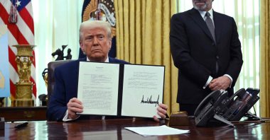 U.S. President Donald Trump displays his signature on an executive order on reciprocal tariffs in the Oval Office of the White House in Washington, D.C., U.S., Feb. 13, 2025. (AFP Photo)