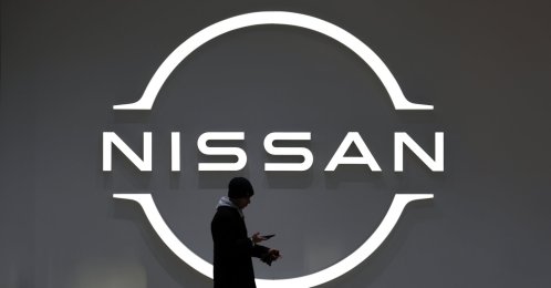 A man walks past the Nissan Motor logo at the carmaker headquarters in Yokohama, near Tokyo, Japan, Feb. 13, 2025. 