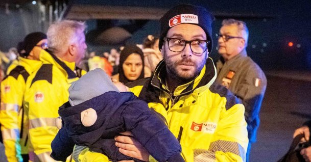 Rescuers and authorities carry children from Gaza in need of care at Linate airport, Milan, Italy, Feb. 14, 2025. (EPA Photo)