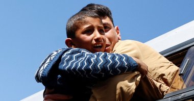 A freed Palestinian prisoner is hugged by a boy after being released by Israel as part of a hostages-prisoners swap between Hamas and Israel, in Khan Younis, in the southern Gaza Strip, Palestine, Feb. 15, 2025. (Reuters Photo)