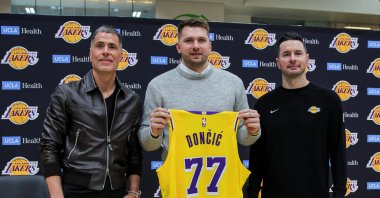 (L-R) Los Angeles GM, Rob Pelinka, Luka Doncic and head coach JJ Reddick pose for a picture as Doncic holds his jersey on the day of his first press conference after being traded from Dallas Mavericks to Los Angeles Lakers, at the UCLA Health Training Center, El Segundo, California, U.S., Feb. 4, 2025. (Reuters Photo)