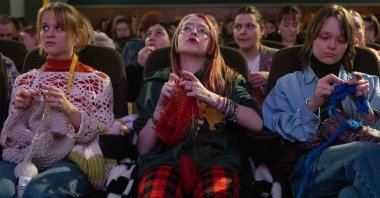 Women knit during the projection of the movie 'The Devil Wears Prada' at the Votive Cinema, Vienna, Austria, Feb. 16, 2025. (AFP Photo)
