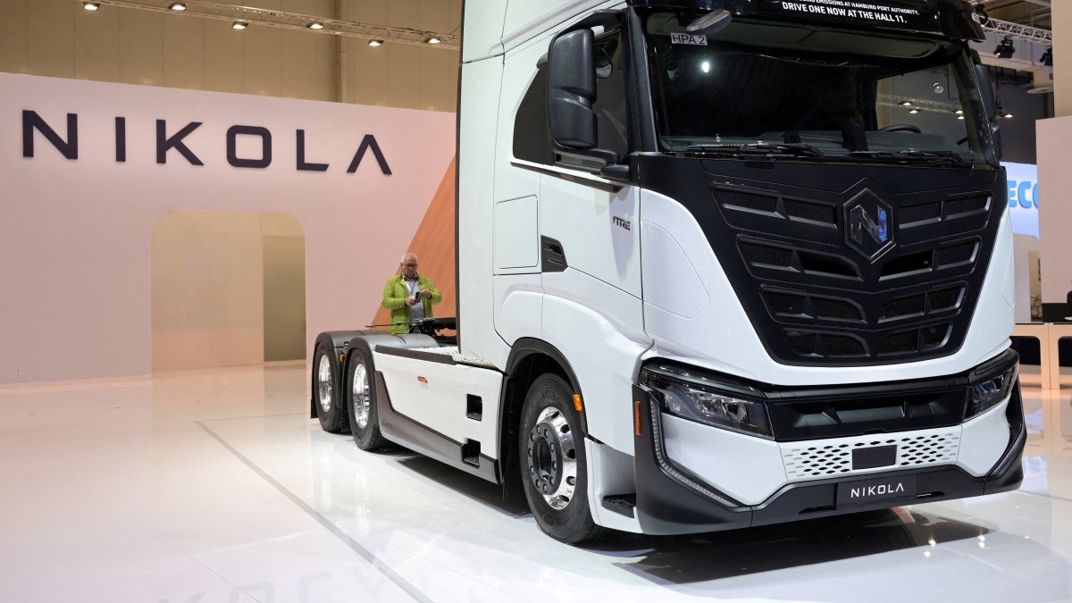 A member of the media stands behind a hydrogen-powered Artic truck at the booth of U.S. truckmaker Nikola at the IAA Transportation fair in Hanover, Germany, Sept. 19, 2022. (Reuters Photo)