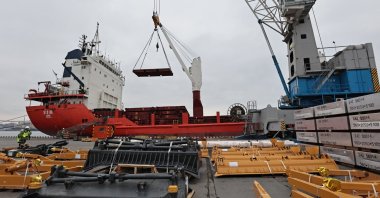 Workers move a cargo of aluminum blocks at a commercial port in Vladivostok, Russia, April 6, 2023. (Reuters Photo)