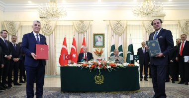 Pakistan and Türkiye's commerce ministers pose for a photo after signing a cooperation agreement, Islamabad, Feb. 12, 2025. (AA Photo)