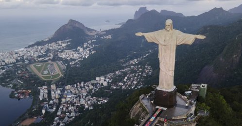 Rugs made from colored salt and sustainable materials lay before the Christ the Redeemer statue before a Catholic Mass celebrating Corpus Christi, Rio de Janeiro, Brazil, May 30, 2024. (AP Photo)