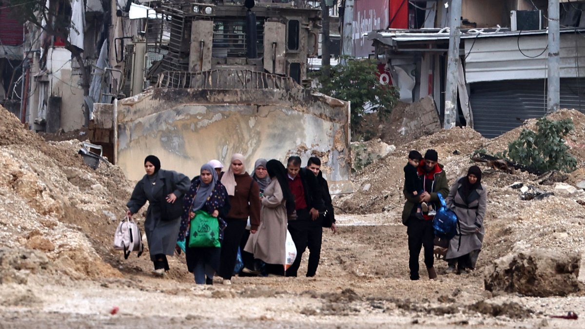 Palestinians leave their home for safety during a raid by the Israeli army in the Nur Shams refugee camp near Tulkarem, occupied West Bank, Palestine, Feb. 11, 2025. (AFP Photo)