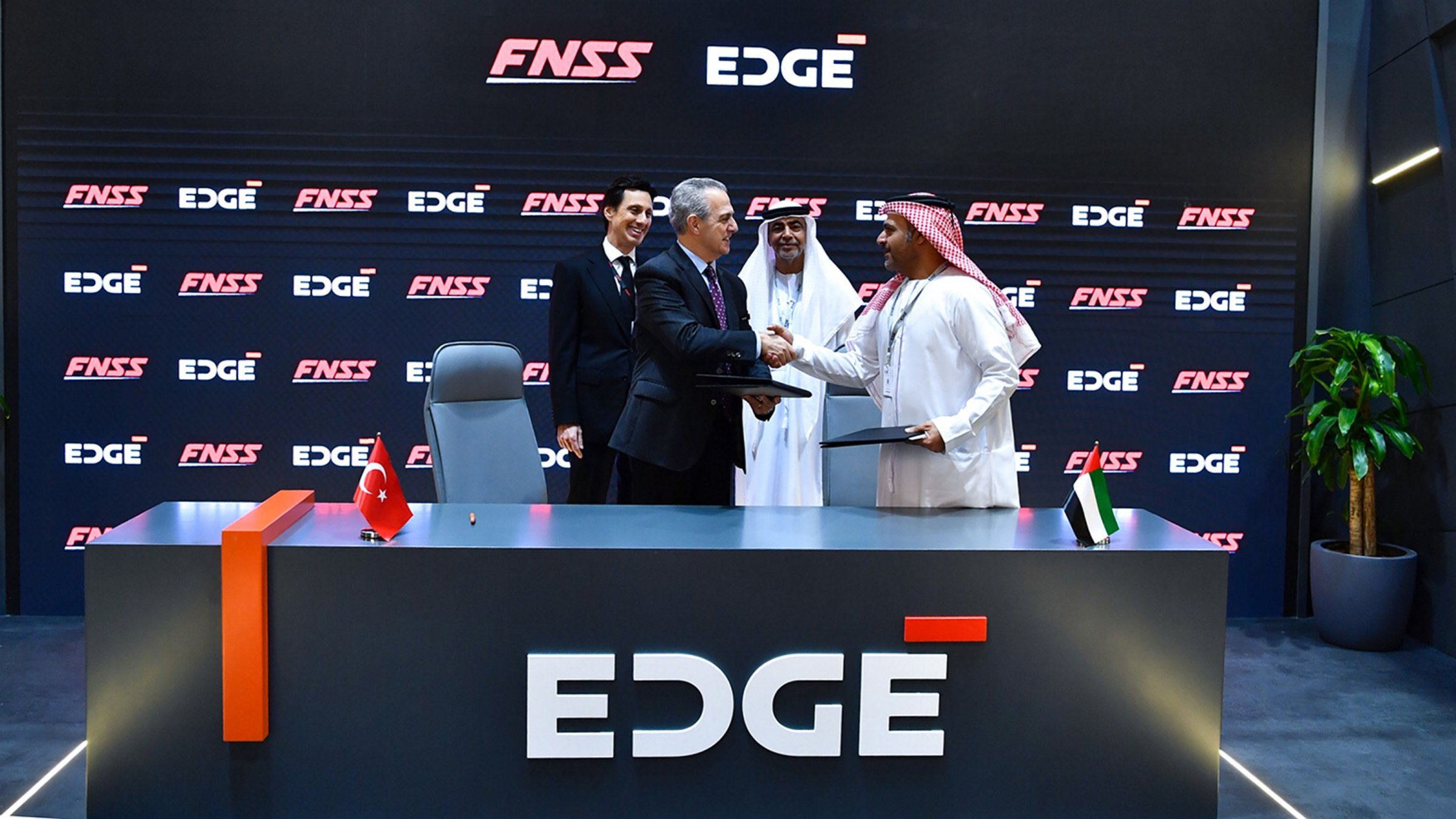 Officials shake hands at the ceremony as Turkish defense company FNSS inks a memorandum of understanding with AL TAIF, an entity of the EDGE Group, to modernize the UAE&#039;s armored fleet, Abu Dhabi, UAE, Feb. 20, 2025. (AA Photo)