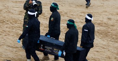Hamas members carry a coffin carrying the body of an Israeli captive, before being handed over to the Red Cross, in Khan Younis, southern Gaza Strip, Feb. 20, 2025. (Reuters Photo)