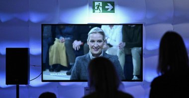 People watch a screen backstage as co-leader and main candidate of the far-right Alternative for Germany (AfD) party Alice Weidel speaks during a TV debate with the main candidates, Berlin, Germany, Feb. 23, 2025. (AFP Photo)