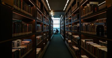 A researcher is seen through the bookshelves at the Presidential Library, Ankara, Türkiye, Feb. 19, 2025. (AA Photo)