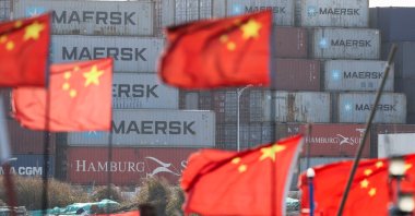 Chinese national flags flutter near shipping containers at the Yangshan Port outside Shanghai, China, Feb. 7, 2025. (Reuters Photo)