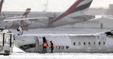 A Delta Air Lines plane lies upside down at Toronto Pearson Airport, Canada, Feb. 18, 2025. (AP Photo)