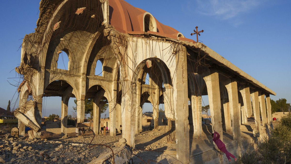 Children play in the ruins of the Church of the Virgin Mary, which was destroyed by Daesh in 2015, Tel Nasri, Syria, Jan. 27, 2025. (AP Photo)