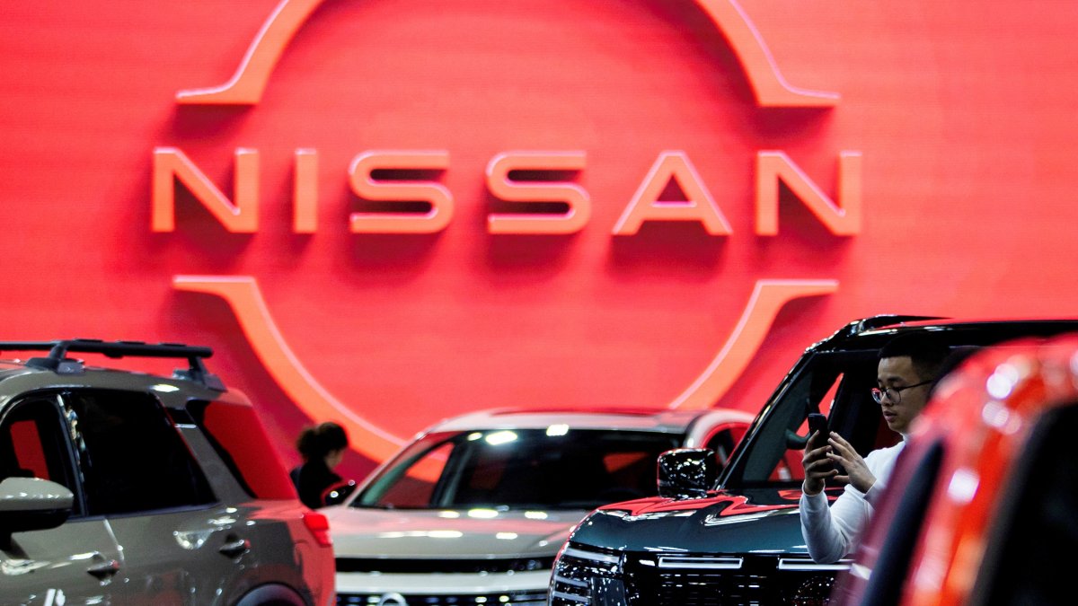A man takes a photo of a Nissan vehicle on display at the Canadian International AutoShow, Toronto, Ontario, Canada, Feb. 13, 2025. (Reuters Photo)