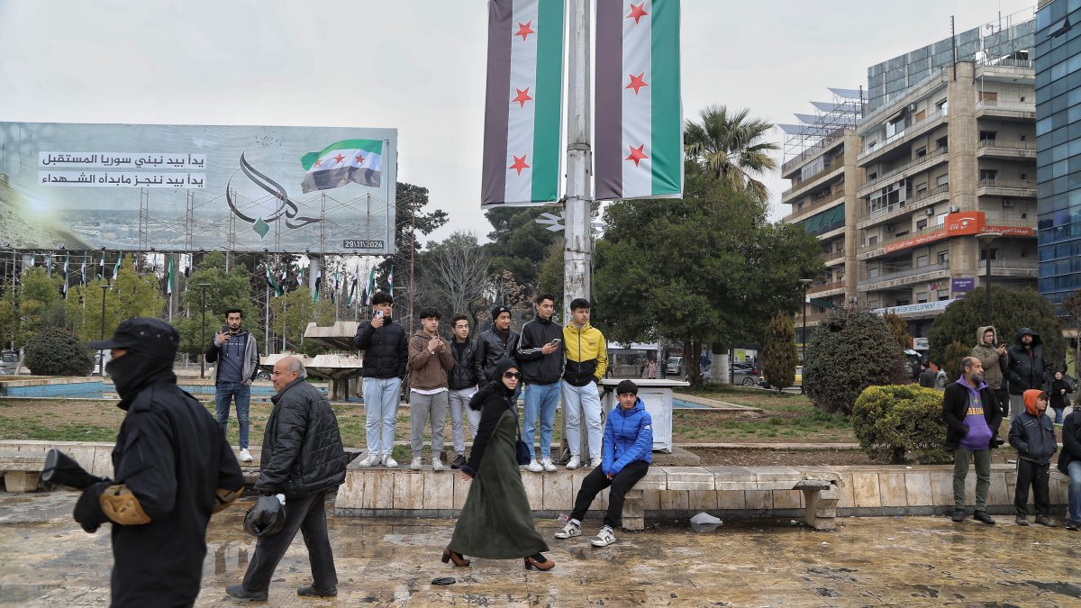 People watch as Syrian soldiers take part in a military parade organized by the Syrian Ministry of Defense following the graduation of over 300 soldiers in the city of Aleppo, northern Syria, Feb. 12, 2025. (EPA Photo)