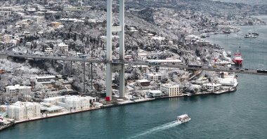 A drone-captured aerial view shows the July 15 Martyrs Bridge and Istanbul’s European side as snowfall blankets the city, Istanbul, Türkiye, Feb. 21, 2025. (AA Photo)