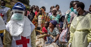 Women sell maize as members of the Congolese Red Cross arrive to bury M23 rebels victims at the Musigiko cemetery, Bukavu, DRC, Feb. 20, 2025. (AFP Photo)