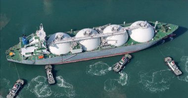 A drone view shows tugboats assisting a liquified natural gas (LNG) tanker to dock at a port in Yantai, Shandong province, China, Feb. 14, 2025. (Reuters Photo)