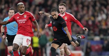 Barcelona's Raphinha tries a shot next to Benfica's Florentino Luis during a Champions League opening phase match at the Luz stadium, Lisbon, Portugal, Jan. 21, 2025. (AP Photo)