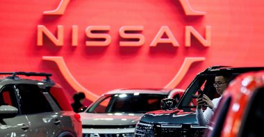A man takes a photo of a Nissan vehicle on display at the Canadian International AutoShow, Toronto, Ontario, Canada, Feb. 13, 2025. (Reuters Photo)