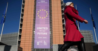 A pedestrian walks past the Berlaymont building, which houses the European Commission headquarters, Brussels, Belgium, Feb. 18, 2025. (AFP Photo)