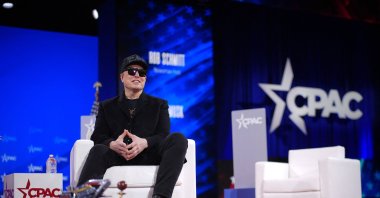 CEO of Tesla and SpaceX Elon Musk sits next to a chainsaw at the Conservative Political Action Conference (CPAC), Oxon Hill, Maryland, U.S., Feb. 20, 2025. (AFP Photo)