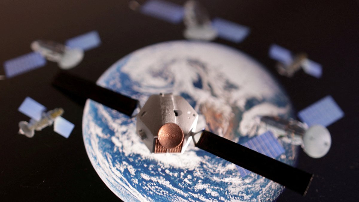 A satellite model is placed on a picture of Earth in this illustration taken Nov. 25, 2024. (Reuters Photo)