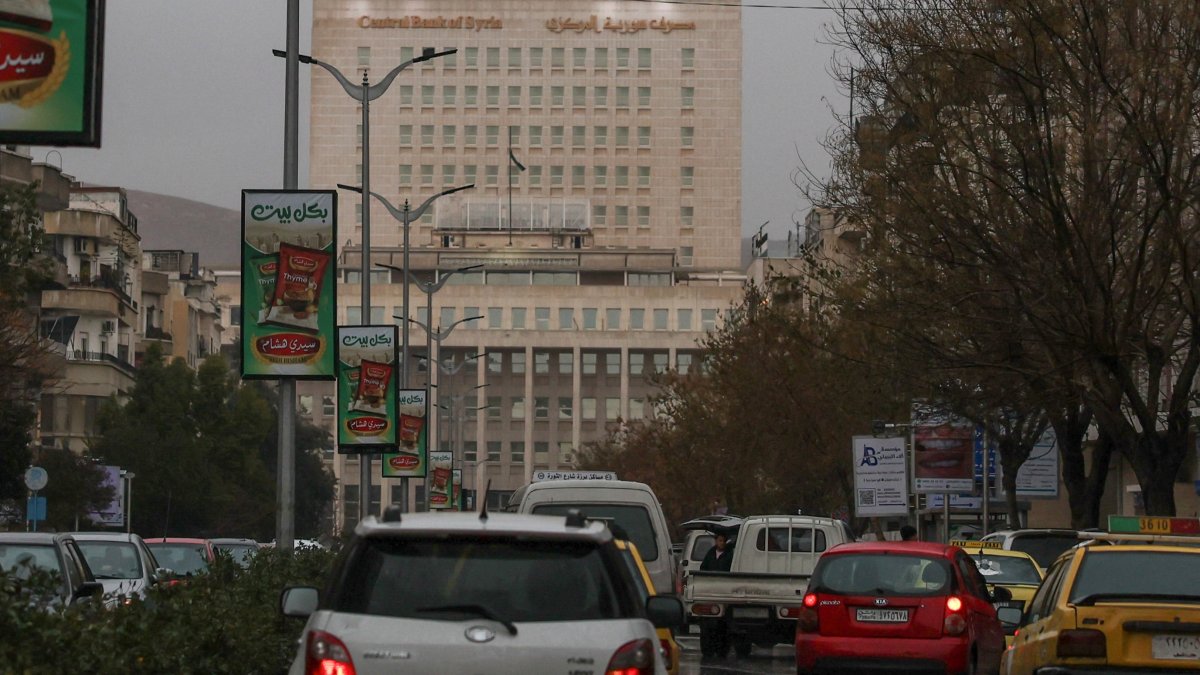 Vehicles drive as the Syrian central bank is seen in the background, Damascus, Syria, Feb. 12, 2025. (Reuters Photo)