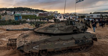 People look on as Israeli tanks enter the Jenin refugee camp in the occupied West Bank, Palestine, Feb. 23, 2025. (AFP Photo)