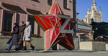 People walk past an installation depicting a red star with a Russian army symbol in front of the main building of the U.S. Embassy in Moscow, Russia, Feb. 24, 2025. (EPA Photo)