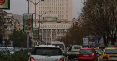 Vehicles drive as the Syrian central bank is seen in the background, Damascus, Syria, Feb. 12, 2025. (Reuters Photo)