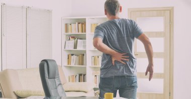 Standing for long periods can lead to low back pain, fatigue, muscle pain and leg swelling, while it can increase the risk of cardiovascular problems and pregnancy complications. (Shutterstock Photo)
