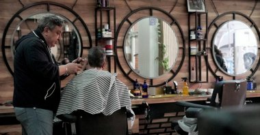 Syrian German Barber Mohammad Azmouz works at a barber shop in the Neukoelln neighborhood, Berlin, Germany, Feb. 24, 2025. (Reuters Photo)