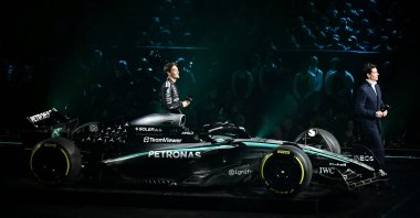 Mercedes&#039; British driver George Russell (C) and Mercedes&#039; Austrian team principal Toto Wolff walk past the new Formula One car of Mercedes Formula One Team during the Formula One 2025 season launch "F1 75 LIVE” event at the O2, London, U.K., Feb. 18, 2025. (AFP Photo)
