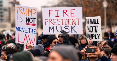 People hold signs as they gather for a "Save the Civil Service" rally hosted by the American Federation of Government Employees (AFGE) outside the U.S. Capitol, in Washington, U.S., Feb. 11, 2025. (AFP Photo)
