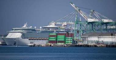 Cargo shipping containers sit stacked at an Evergreen container terminal across from the Royal Caribbean Navigator of the Seas cruise ship at the Port of Los Angeles in Los Angeles, California, U.S., Feb. 3, 2025. (AFP Photo)
