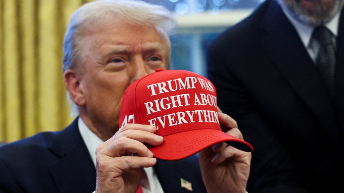 U.S. President Donald Trump holds a hat after signing an executive order in the Oval Office, at the White House, Washington, U.S. Feb. 25, 2025. (Reuters Photo)