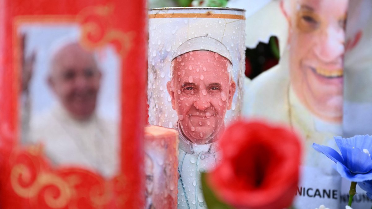 Candles and messages of healing for Pope Francis are laid at the statue of John Paul II outside the Gemelli hospital where the Pope is hospitalized with pneumonia, in Rome, Italy, Feb. 26, 2025. (AFP Photo)