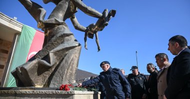 People leave flowers at a monument in memory of the Khojaly Massacre victims, at a ceremony in Ankara, Türkiye, Feb. 25, 2025. (AA Photo)