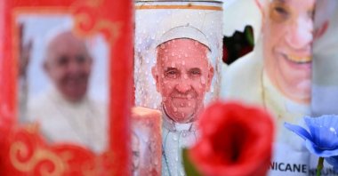 Candles and messages of healing for Pope Francis are laid at the statue of John Paul II outside the Gemelli hospital where the Pope is hospitalized with pneumonia, in Rome, Italy, Feb. 26, 2025. (AFP Photo)