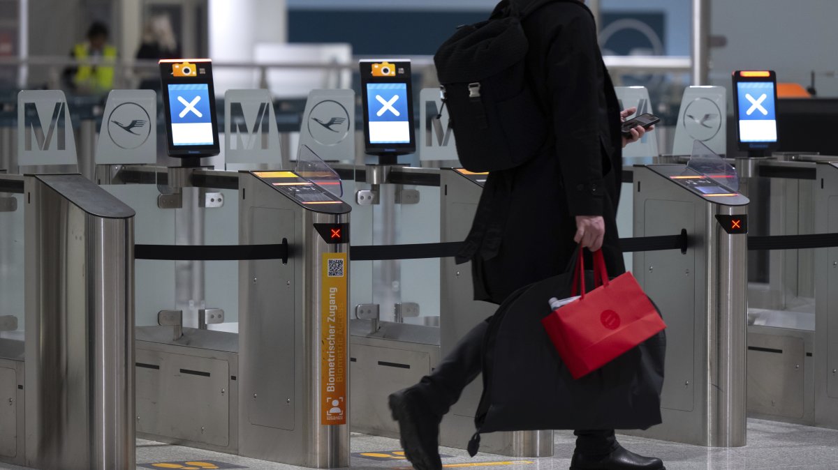 A passenger walks past closed security gates security at the Munich Airport, Munich, Germany, Feb. 27, 2025. (AP Photo)