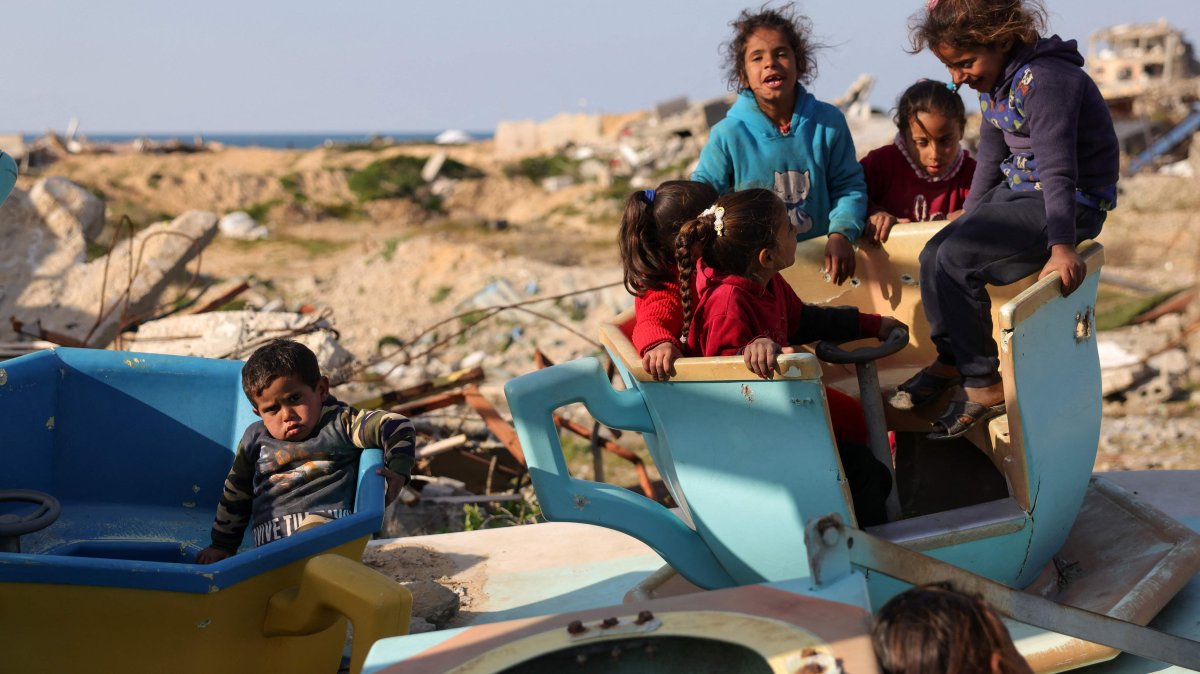 Palestinian children play in a war-damaged merry-go-round at the destroyed children&#039;s park west of Jabalia, northern Gaza Strip, Palestine, Feb. 26, 2025. (AFP Photo)