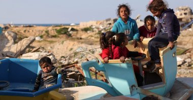 Palestinian children play in a war-damaged merry-go-round at the destroyed children&#039;s park west of Jabalia, northern Gaza Strip, Palestine, Feb. 26, 2025. (AFP Photo)