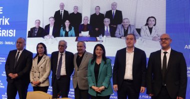 Delegation members of the DEM Party pose at a news conference held after a visit with jailed PKK terrorist leader Abdullah Öcalan (seen in the on-screen photo, center), Istanbul, Türkiye, Feb. 27, 2025. (EPA Photo)