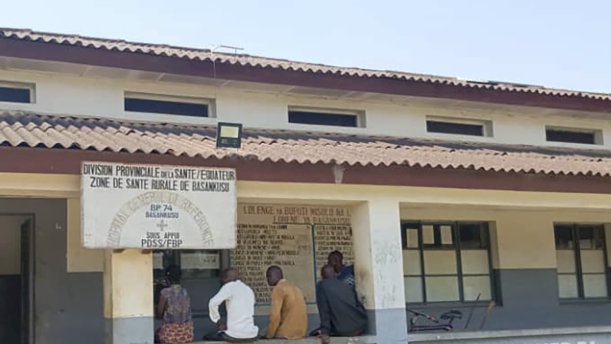 Men sit outside the general hospital where some victims of unidentified illnesses are being treated, Basankusu, DRC, Feb. 27, 2025. (AP Photo)