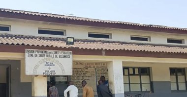 Men sit outside the general hospital where some victims of unidentified illnesses are being treated, Basankusu, DRC, Feb. 27, 2025. (AP Photo)