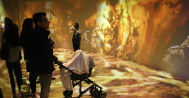 Visitors examine the virtual simulation of Göbeklitepe&#039;s history in Şanlıurfa, Türkiye, Nov. 17, 2024. (AA Photo)