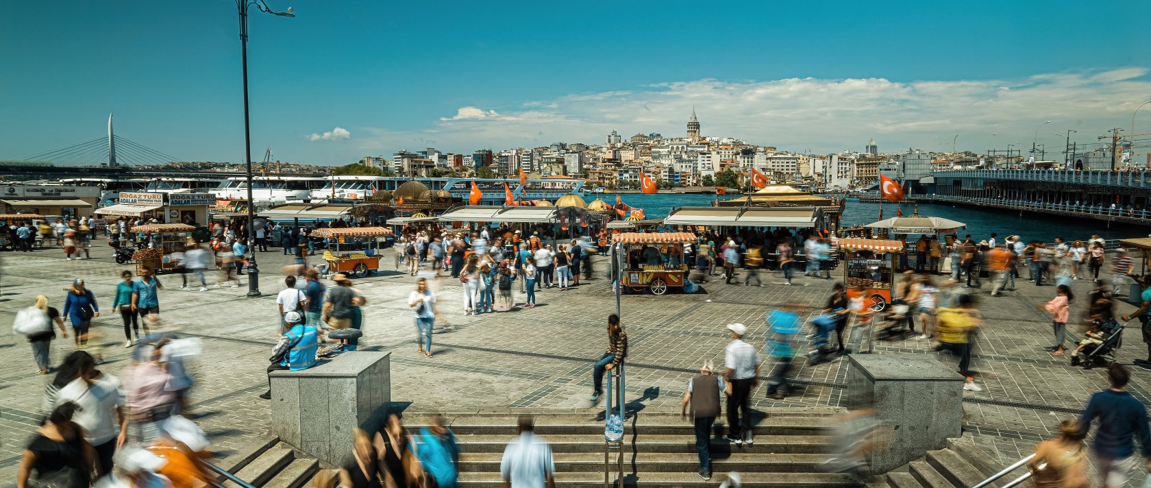 People walk in Eminönü, famous for fish and bread boats, Istanbul, Türkiye, June 20, 2021. (Shutterstock Photo)