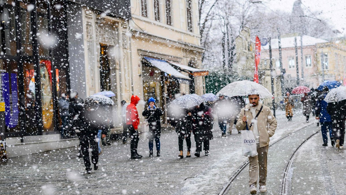 People walk along Istiklal Street as snow falls, Istanbul, Türkiye, Feb. 19, 2025. (AFP Photo)
